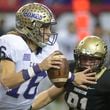 Cartersville quarterback Trevor Lawrence (16) eludes Thomson defensive Will Roberts in a 2016 game. AJC file photo