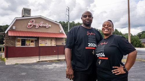 Jaybee’s Tenders co-founders Erika Harrington and her husband William Harrington pose for a portrait outside the restaurant in Decatur, GA on Thursday, July 25, 2024. (Seeger Gray / AJC)