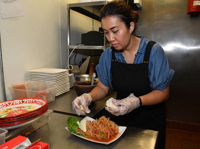 Chef Thip Athakhanh prepares traditional Lao papaya salad at Snackboxe Bistro in Duluth. (CHRIS HUNT FOR THE ATLANTA JOURNAL-CONSTITUTION)