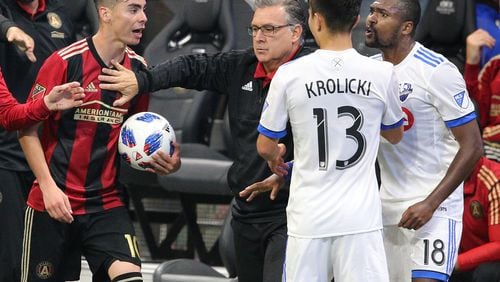 April 28, 2018 Atlanta: Atlanta United head coach Gerardo Martino breaks up a heated confrontation between Miguel Almiron (left) and Montreal Impact player Chris Duval (right) during the second half in a MLS soccer match on Saturday, April 28, 2018, in Atlanta.  Curtis Compton/ccompton@ajc.com