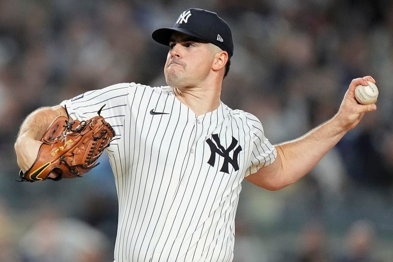 New York Yankees pitcher Carlos Rodón delivers against the Kansas City Royals during the first inning of Game 2 of the American League baseball playoff series, Monday, Oct. 7, 2024, in New York. (AP Photo/Frank Franklin II)