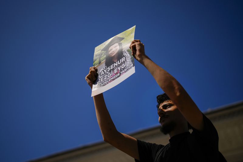 A man holds up a photograph of Aysenur Ezgi Eygi, 26 year-old Turkish-American activist killed by the Israeli military, during a protest in her memory in Istanbul, Turkey, Saturday, Sept. 14, 2024. (AP Photo/Francisco Seco)