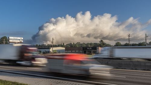 A large plume caused by a chemical reaction is still visible over the BioLab facility in Conyers, where a fire broke out Sunday.