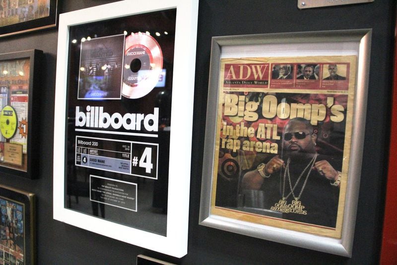 Framed recording plaques and news clippings related to Big Oomp's career hang from the dining room walls inside BOSK.