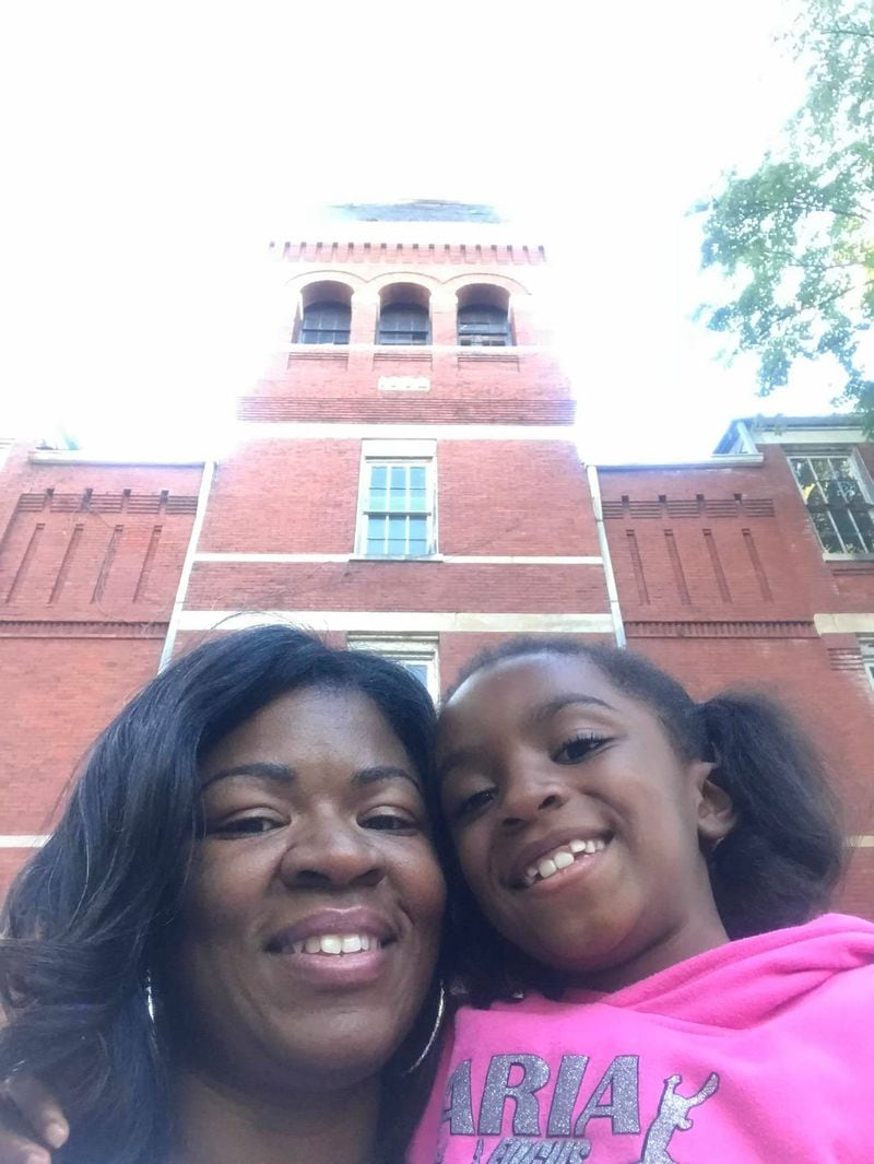 Melva Robertson and her daughter Aria Robertson, in front of Morris Brown’s Fountain Hall this fall. Robertson’s mother Florence Jackson Bell graduated from Morris Brown in 1965, and they hope the school will be around for Aria. (Courtesy Melva Robertson)