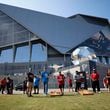 Panthers fan Benjamin Willis and Falcons fan Steven Lance (center) are seen playing corn hole by the Home Depot backyard before the Falcons season opener against the Carolina Panthers on Sunday, Sept. 10, 2023, in Atlanta.
Miguel Martinz/miguel.martinezjimenez@ajc.com