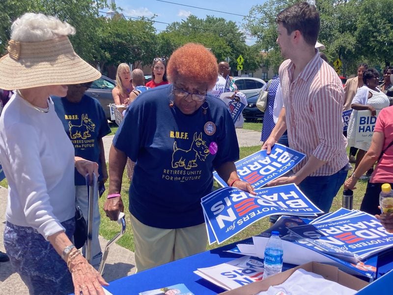 Supporters of President Joe Biden claim campaign promotion materials during the opening celebration for the "Black Voters for Biden-Harris" field office in Savannah. 