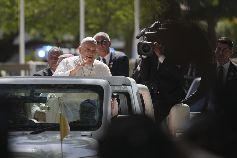 Pope Francis waves from the car, in Dili, East Timor, Monday, Sept. 9, 2024. (AP Photo/Dita Alangkara)