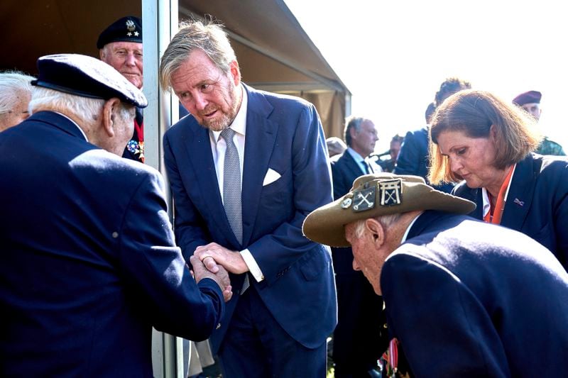 King Willem Alexander of the Netherlands, center, meets some surviving veterans in Ginkel Heath Netherlands, Saturday, Sept. 21, 2024, to mark the 80th anniversary of an audacious by unsuccessful World War II mission codenamed Market Garden to take key bridges in the Netherlands. (AP Photo/Phil Nijhuis)