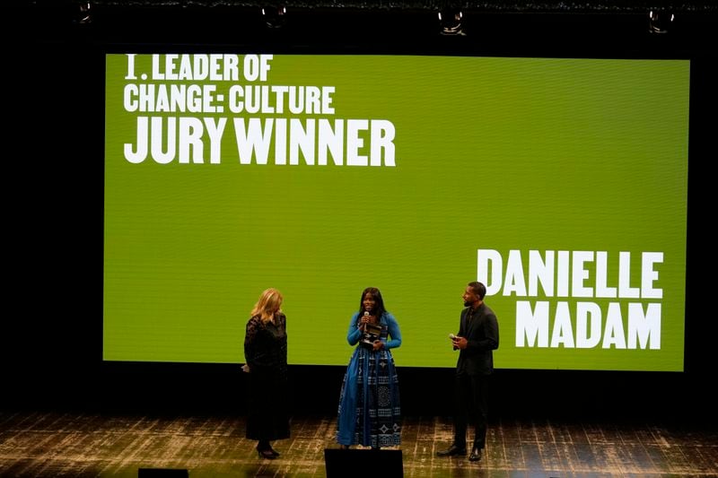 Danielle Madam, center, talks after winning in the Culture category of the second edition of the 'Black carpet awards' in Milan, Italy, Friday, Sept. 20, 2024. (AP Photo/Luca Bruno).