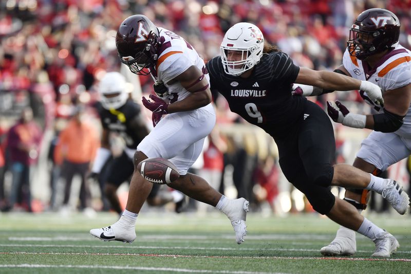 FILE - Louisville defensive lineman Ashton Gillotte (9) punches the ball away from Virginia Tech running back Bhayshul Tuten (33) during the second half of an NCAA college football game in Louisville, Ky., Saturday, Nov. 4, 2023. (AP Photo/Timothy D. Easley, File)