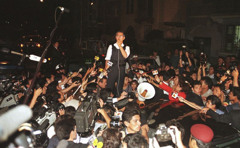 FILE - Peruvian President Alberto Fujimori gives a press conference in front of the Japanese ambassador's residence in Lima, Peru, April 22, 1997. (AP Photo/Eugene Hoshiko, File)