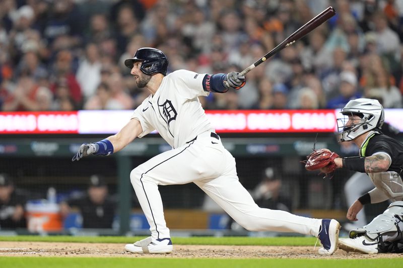 Detroit Tigers' Matt Vierling hits a sacrifice fly to score Parker Meadows during the fifth inning of a baseball game, Friday, Sept. 27, 2024, in Detroit. (AP Photo/Carlos Osorio)