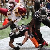 Washington Football Team running back J.D. McKissic gets into the end zone for the game-winning touchdown with Falcons cornerback A.J. Terrell (left) and safety Duron Harmon arriving late with the hit during the final minute Sunday, Oct. 3, 2021, at Mercedes-Benz Stadium in Atlanta. The Falcons lost 34-30. (Curtis Compton / Curtis.Compton@ajc.com)