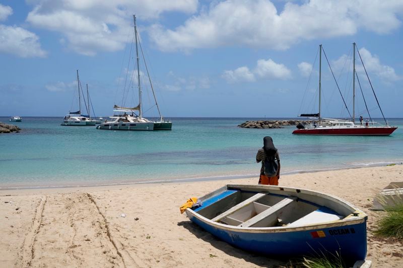 Sailboats line up to enter a marina ahead of the arrival of Hurricane Beryl in Speightstown, Barbados, Sunday, June 30, 2024. (AP Photo/Ricardo Mazalan)