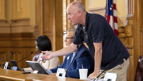 FILE - State Election Board member Rick Jeffares asks the crowd to settle down during a hastily planned State Election Board meeting at the Capitol in Atlanta on Friday, July 12, 2024. The Georgia State Election Board, which once toiled in relative obscurity, now hosts raucous meetings where public comment spans several hours and attendees regularly heckle its members. (Arvin Temkar/Atlanta Journal-Constitution via AP, File)