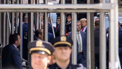 
                        Former President Donald Trump waves as he arrives at the Manhattan Criminal Courthouse in Manhattan, April 4, 2023. The former president is expected to appear today in a Manhattan courtroom and plead not guilty to charges related to his role in a hush-money payment to a porn star in the last days of the 2016 presidential campaign. (Benjamin Norman/The New York Times)
                      