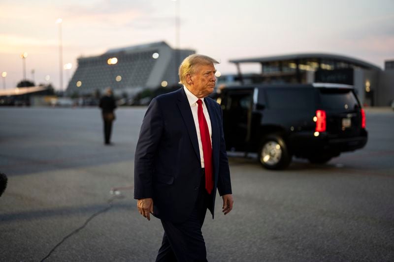 Former President Donald Trump walks at Hartsfield-Jackson International Airport shortly after being booked Aug. 24, at the Fulton County Jail on charges involving meddling in Georgia's 2020 presidential election. (Doug Mills/The New York Times)
                      
