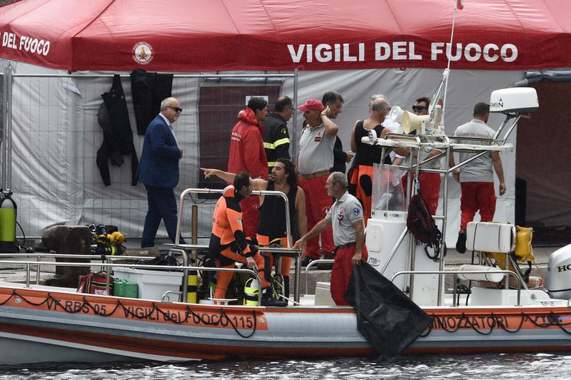 Italian firefighters scuba divers are docked at the harbor of Porticello, southern Italy, Tuesday, Aug. 20, 2024, as rescue teams returned to the site of a storm-sunken superyacht to search for six people, including British tech magnate Mike Lynch, who are believed to be still trapped in the hull 50 meters (164-feet) underwater. (AP Photo/Salvatore Cavalli)