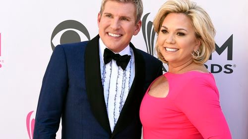 FILE - Julie Chrisley, right, and her husband Todd Chrisley pose for photos at the 52nd annual Academy of Country Music Awards on April 2, 2017, in Las Vegas. (Jordan Strauss/Invision/AP, File)