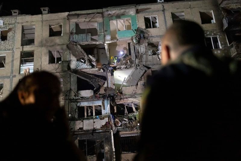 Rescue workers clear the rubble inside a building damaged by a Russian airstrike in Kharkiv, Ukraine, Thursday Oct. 3, 2024. (AP Photo/Yevhen Titov)