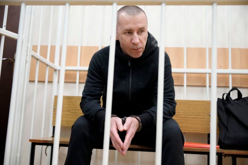 Former Navalny's lawyer Igor Sergunin sits in the cage during a court session in Petushki, Vladimir region, about 120 kilometers (75 miles) east of Moscow, Russia, Thursday, Sept. 12, 2024. (AP Photo/Alexander Zemlianichenko)