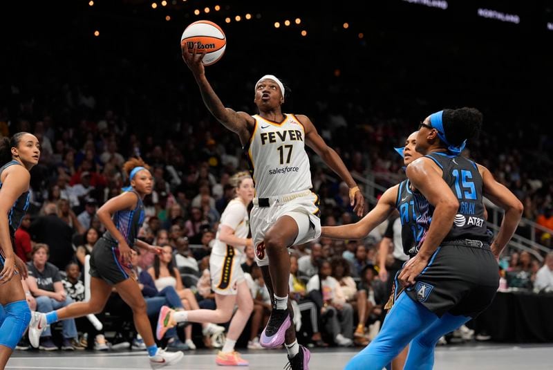 Indiana Fever guard Erica Wheeler (17) drives to basket against Atlanta Dream guard Allisha Gray (15) during the second half of a WNBA basketball game Friday, June 21, 2024, in Atlanta. (AP Photo/John Bazemore)