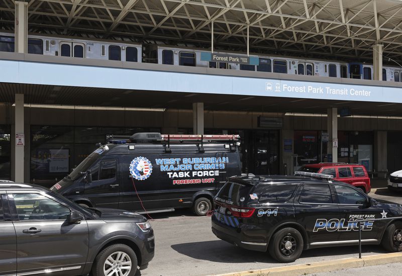 Police vehicles are parked outside the CTA Forest Park station, Monday, Sept. 2, 2024, in Forest Park, Ill. (John J. Kim/Chicago Tribune via AP)