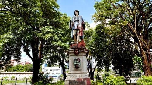 A vandalized statue of Christopher Columbus towers over Columbus Square in Port of Spain, Trinidad and Tobago, Wednesday, Aug. 28, 2024. Officials in the Caribbean island nation are reviewing on whether to remove statues, signs and monuments that reference European colonization. (AP Photo/Robert Taylor)