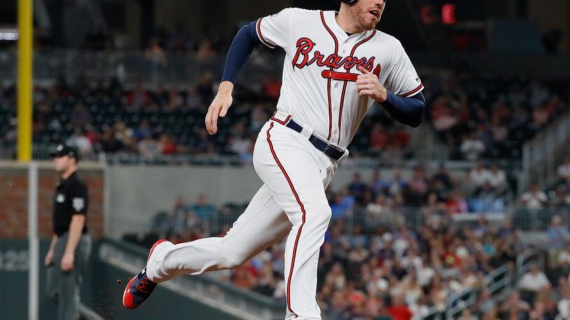 Atlanta Braves left fielder Lane Adams wears a jersey sporting a