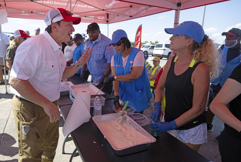 Louisiana Governor Jeff Landry greets volunteers following Hurricane Francine in Houma, La., Friday, Sept. 13, 2024. (Hilary Scheinuk/The Advocate via AP, Pool)