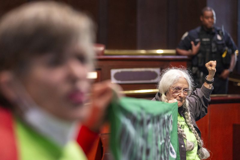 Opponents of the under-construction law enforcement training center known to some as Cop City disrupt the City Council meeting at City Hall in Atlanta on Monday, Sept. 16, 2024. (Arvin Temkar/Atlanta Journal-Constitution via AP)