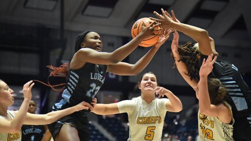 March 11, 2022 Macon - Lovejoy's La'nya Foster (23) and Lovejoy's Layla Hood (right) grab a rebound during the 2022 GHSA State Basketball Class AAAAAA Girls Championship game at the Macon Centreplex in Macon on Friday, March 11, 2022. Lovejoy won 54-38 over Sequoyah. (Hyosub Shin / Hyosub.Shin@ajc.com)