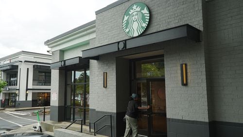 An employee enters a Starbucks location on Ponce de Leon Ave. in Atlanta, Ga., on Saturday, July 20, 2024. The coffeehouse chain experienced disruptions to some of its mobile order and payment services due to a global IT outage on Friday, July 19, 2024.