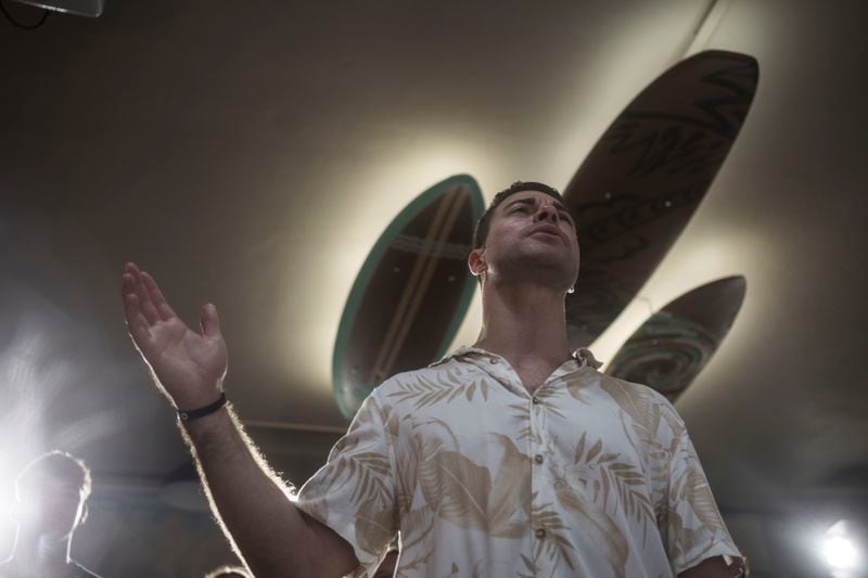 Surf Church pastor, the Rev. Samuel Cianelli, preaches to his congregation at the church in Porto, Portugal on Sunday, Aug. 18, 2024. (AP Photo/Luis Andres Henao)