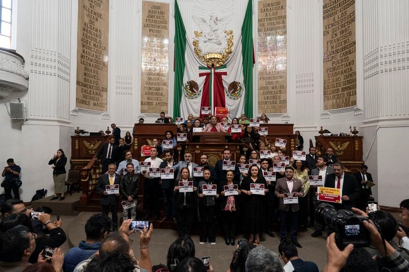 Mexico City lawmakers in favor of judicial reform pose for photos at the city Congress in Mexico City, Thursday, Sept. 12, 2024. (AP Photo/Felix Marquez)