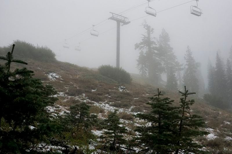 A coating of snow is seen below ski lifts at Sugarbowl Ski Resort Saturday, Aug. 24, 2024, in Donner Summit, Calif. (AP Photo/Brooke Hess-Homeier)