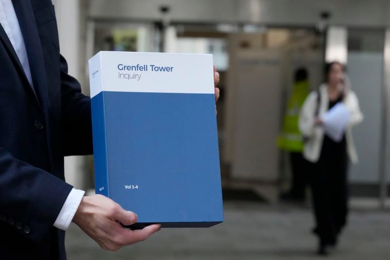 A copy of the Grenfell Tower Inquiry report is shown in London, Wednesday, Sept. 4, 2024, the fire in which 72 people were killed in June 2017, issued Wednesday the on the Grenfell Tower fire, the report says decades of failure by government and industry made the high-rise a "death trap". (AP Photo/Frank Augstein)