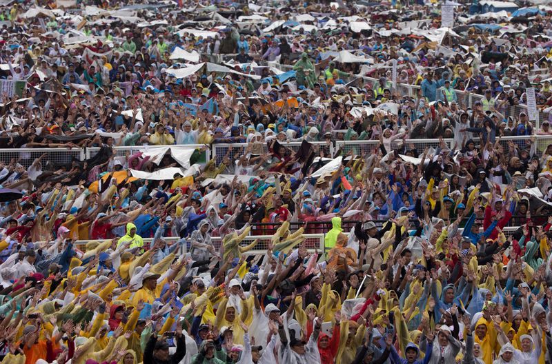 FILE - Worshippers cheer as they wait for the arrival of Pope Francis at Rizal Park in Manila, Philippines on Sunday, Jan. 18, 2015. (AP Photo/Alessandra Tarantino, File)