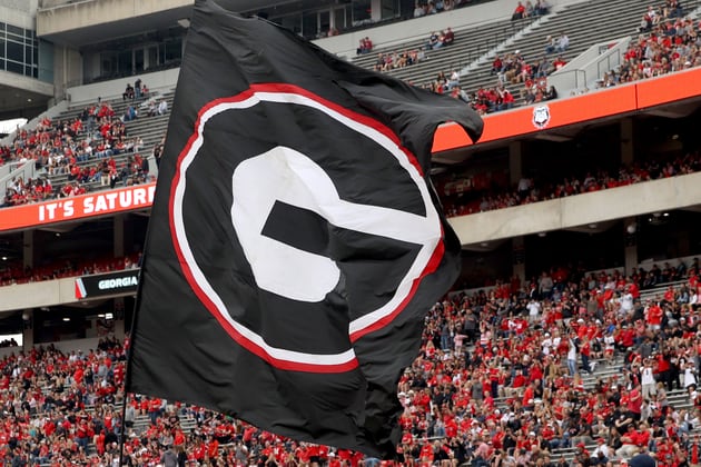 A Georgia flag is run onto the field before the G - Day game at Sanford Stadium Saturday, April 16, 2022, in Athens, Ga. (Jason Getz / Jason.Getz@ajc.com)