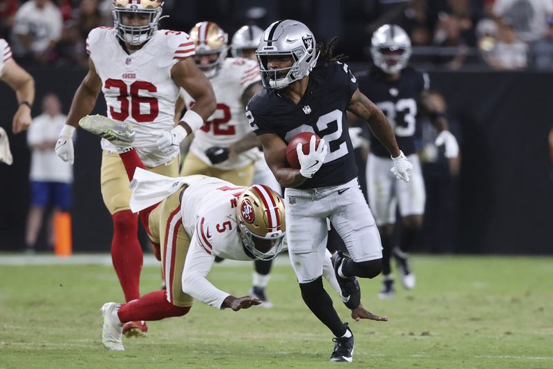 Las Vegas Raiders wide receiver Tyreik McAllister (32) returns a punt to score a touchdown against the San Francisco 49ers during the first half of an NFL preseason football game, Friday, Aug. 23, 2024, in Las Vegas. (AP Photo/Ian Maule)