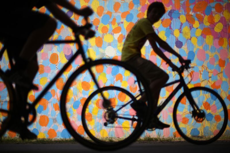 Bicyclists cruise along the Beltline past a mural by HENSE under Virginia Avenue while taking advantage of the beautiful weather Monday afternoon May 4, 2015. Ben Gray/bgray@ajc.com 