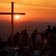 The sun rises behind the cross during Easter sunrise service on top of Stone Mountain on Sunday, March 31, 2024.   (Ben Gray / Ben@BenGray.com)