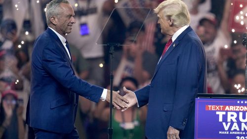 Independent presidential candidate Robert F. Kennedy Jr., left, shakes hands with Republican presidential nominee former President Donald Trump at a campaign rally Friday, Aug. 23, 2024, in Glendale, Ariz. (AP Photo/Ross D. Franklin)