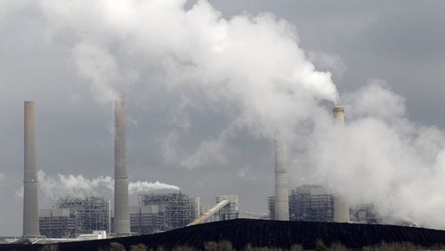 Exhaust rises from smokestacks in front of piles of coal in Thompsons, Texas. In Georgia, state officials recently brought an end to a 12-year effort to build a new coal plant in Washington County. Plant Washington was believed to have been the last new coal plant proposed for construction in the nation. AP PHOTO / DAVID J. PHILLIP, FILE