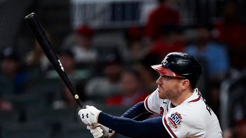 Atlanta Braves' Freddie Freeman (5) follows through on a double during the fifth inning of the team's baseball game against the New York Mets on Wednesday, June 30, 2021, in Atlanta. (AP Photo/John Bazemore)