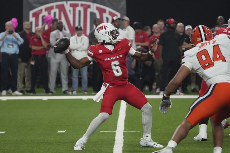 UNLV quarterback Hajj-Malik Williams (6) looks to throw downfield against Syracuse in the first half during an NCAA college football game, Friday, Oct. 4, 2024, in Las Vegas. (AP Photo/Rick Scuteri)