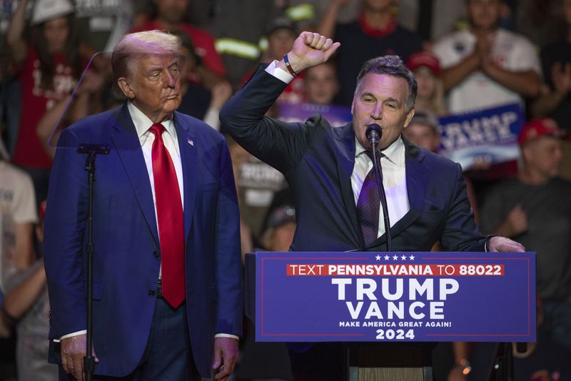 Republican presidential nominee former President Donald Trump, left, listens as Dave McCormick, Republican candidate for U.S. Senate in Pennsylvania, shouts "fight, fight, fight" during a campaign rally at Ed Fry Arena in Indiana, Pa., Monday, Sept. 23, 2024. (AP Photo/Rebecca Droke)