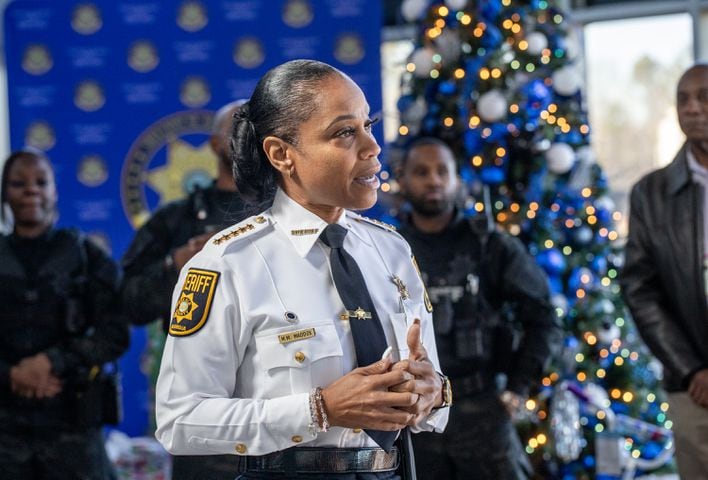 DeKalb County Sheriff Melody M. Maddox welcomes families to the 16th annual Adopt-A-Family celebration on Tuesday, Dec 16, 2023. Law enforcement officers donate their own money and buy gifts for about a dozen local children.  (Jenni Girtman for The Atlanta Journal-Constitution)