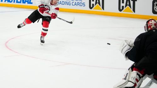 New Jersey Devils' Ondřej Palat takes a shot during a practice session, a day before their NHL hockey game against Buffalo Sabres, in Prague, Czech Republic, Thursday, Oct. 3, 2024. (AP Photo/Petr David Josek)